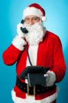 Modern Santa Passing Greetings Over A Phone Call Stock Photo