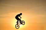 Silhouetted Bicycle Rider Stock Photo