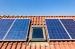 Blue Solar Collectors And Attic Window Stock Photo