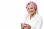 Smiling Woman Enjoying Music With Her Mobile Phone Stock Photo