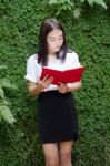 Thai Adult Student University Beautiful Girl Reading Red Book Stock Photo