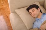 Man Sleeping On The Couch Stock Photo