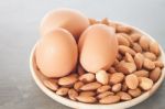 Almond Nuts And Eggs On Wooden Plate Stock Photo