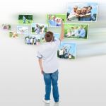 Young Boy Choosing His Outdoor Photo To Share Stock Photo