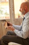 Businessman Middle-aged Working From Home With A Tablet Stock Photo