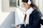 Beautiful Girl Listening To Music In City Stock Photo