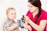 Mother Feeding Child With Grape Stock Photo