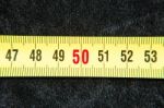 Centimeters Near A Tape Measure On The Number Fifty Stock Photo