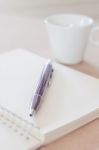 Pen And Spiral Notebook With Coffee Cup Stock Photo