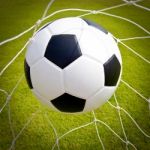 Football Ball In Goal Net Stock Photo