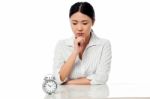 Serious Business Lady Staring At Alarm Clock Stock Photo