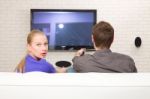 Man Watching Tv Woman Looking Back Stock Photo