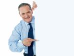 Businessman Peeping Behind board Stock Photo