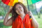 Happy Fatty Woman With Umbrella Stock Photo