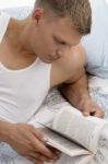 Handsome Male Reading Book Stock Photo