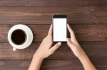 Phone White Screen In Woman Hand On Table Top View Stock Photo