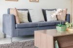 Three Of Pillows On Dark Blue Sofa In Modern Living Room Stock Photo