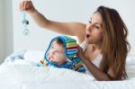 Mother And Baby Playing And Smiling At Home Stock Photo