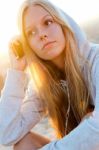 Beautiful Girl Sitting On The Roof And Listening To Music Stock Photo