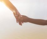 Two Hands Holding Puzzle Mother And Child Stock Photo