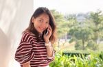 Younger Asian Woman Talking On Smart Phone With Happiness Emtion Stock Photo