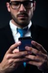 Handsome Stylish Man In Elegant Black Suit Using Mobile Phone Stock Photo