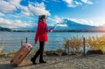 Tourist With Baggage And Map At Fuji Mountain, Kawaguchiko In Japan Stock Photo