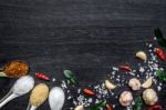 Top View Of Food Ingredients And Condiment On The Table, Ingredients And Seasoning On Dark Wooden Floor Stock Photo