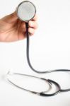 Hand On Stethoscope On White Background Stock Photo