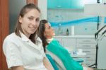 Dentist Examining A Patient's Teeth In The Dentist Stock Photo