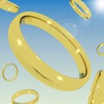 Golden Rings Falling From Sky Stock Photo