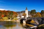 Colorful Autumn Day In Ancient Village With Old Bridge And Churc Stock Photo