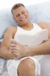 Handsome Male Reading Book Stock Photo