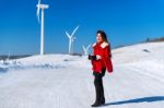 Young Woman Is A Happiness With Camera In Winter Of Sky And Winter Road With Snow And Red Dress Stock Photo