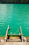 Ladder Made Of Wood Into The Water Stock Photo