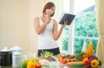 Young Woman Reads Cookbook Stock Photo