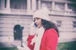 Beautiful Woman In Red Coat And Wool Cap And Gloves With Smartph Stock Photo