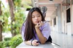 Portrait Of Thai High School Student Uniform Teen Beautiful Girl Using Her Phone And Smile Stock Photo