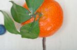 Tangerine And Blueberry On White Table Stock Photo