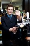 Bartender holding glass Stock Photo