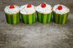 Delicious Cupcakes On The Wooden Floor Stock Photo