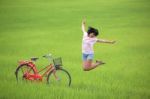 Girl Jumping In Paddy Field Stock Photo