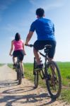 Happy Young  Couple On A Bike Ride In The Countryside Stock Photo