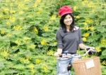 Portrait Of An Happy Smiling Girl Riding A Bicycle In The Park Stock Photo