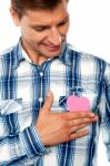 Smiling Young Man Touching Heart Stock Photo