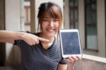 Portrait Of Thai Adult Beautiful Girl Using Her Tablet Stock Photo