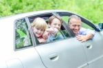 Father Enjoying Car Drive With His Kids Stock Photo