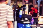 Men Waiting For A Change Of Tires Stock Photo