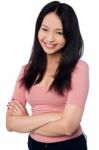 Pretty Asian Girl Posing Casually, Arms Folded Stock Photo