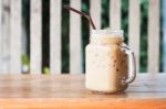 Glass Of Iced Coffee On Wooden Table With Vintage Filter Style Stock Photo